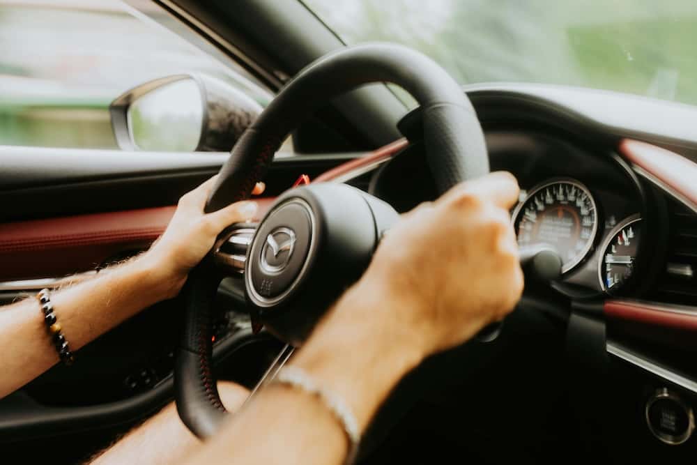 Person test driving a Mazda car