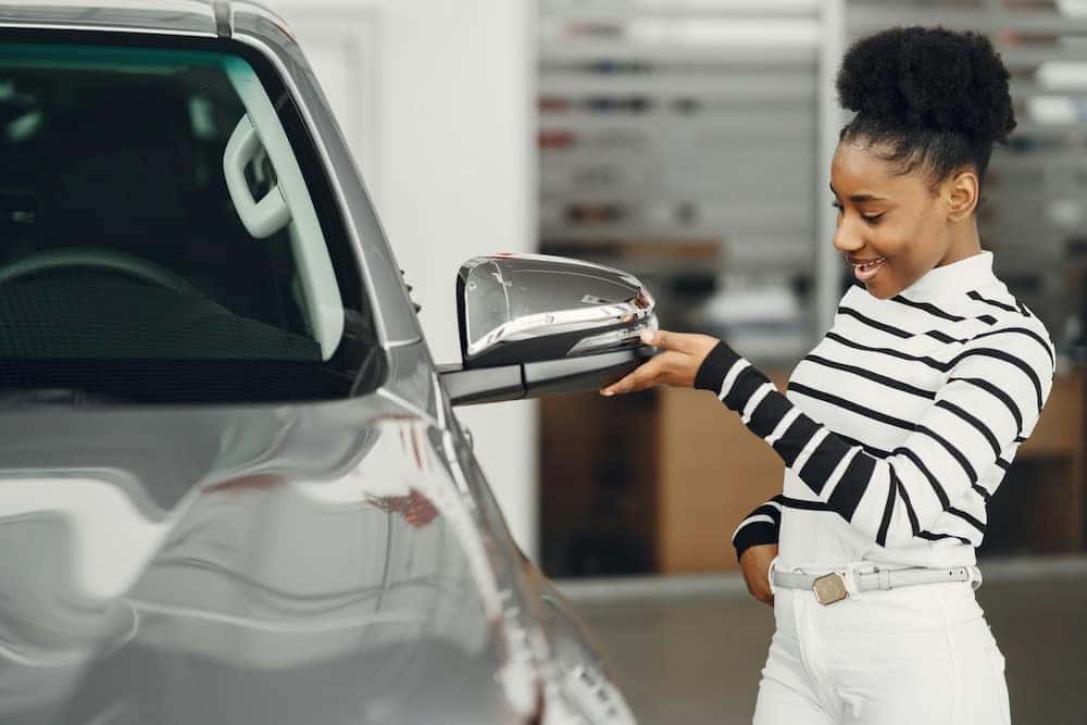 A woman inspects a used SUV for sale in Richmond