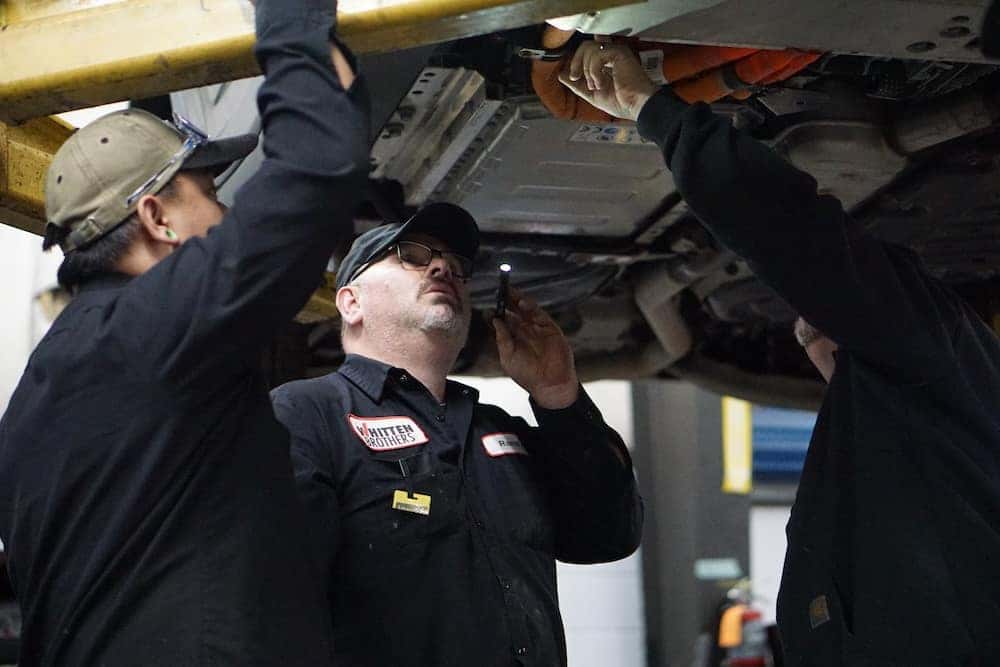 Whitten Brothers auto service technicians inspecting a vehicle