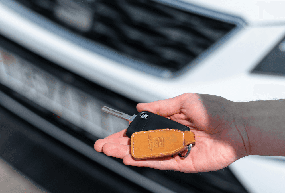 Person handing over their car keys as they trade in a vehicle to a Richmond car dealership