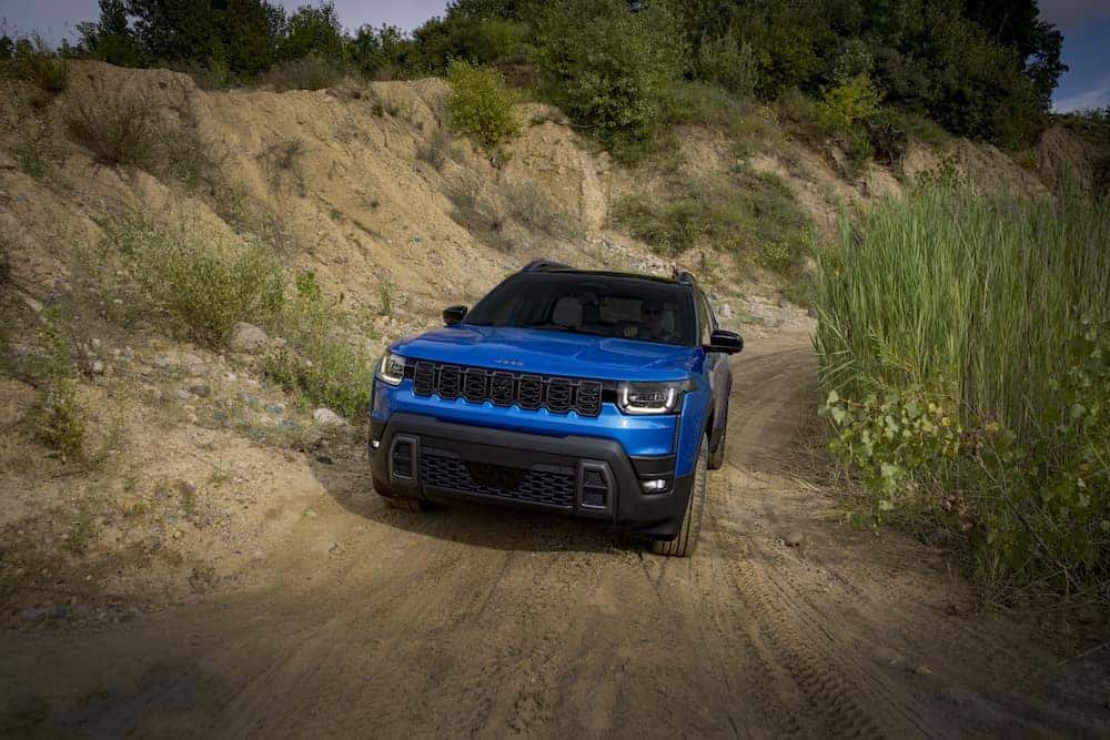 2026 Jeep Grand Cherokee off-road driving on a dirt road
