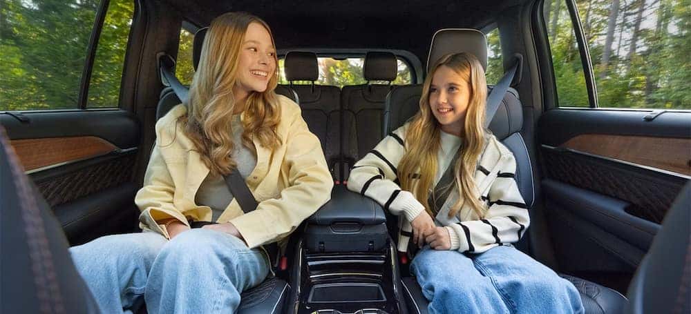 Two girls riding in the 2026 Jeep Grand Cherokee L. This is a three row SUV with the long wheelbase.
