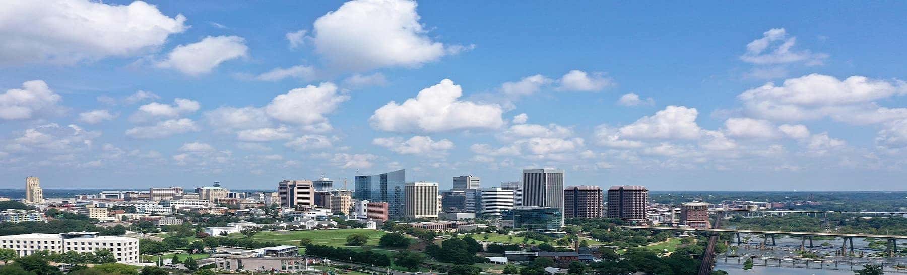 Beautiful shot of Richmond, Virginia skyline with a cloudy blue sky in the background
