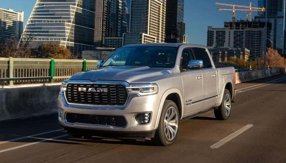 RAM 1500 exterior. RAM truck driving through a city.