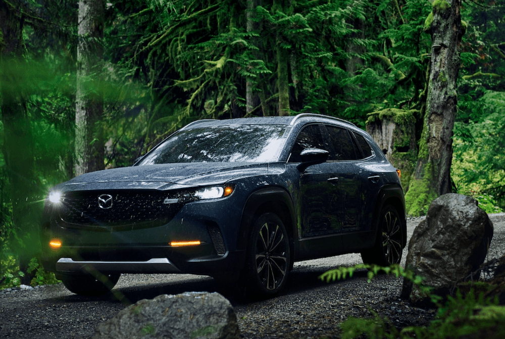 2025 Mazda CX-50 exterior with headlights on