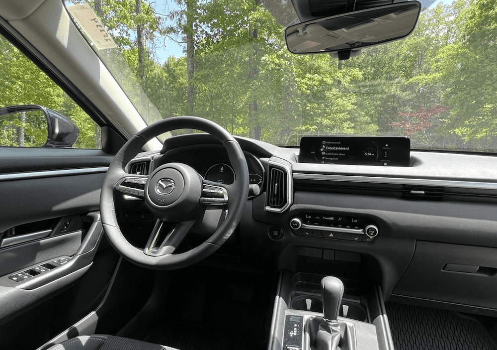 2025 Mazda CX-50 interior with steering wheel, gear shift, and center screen