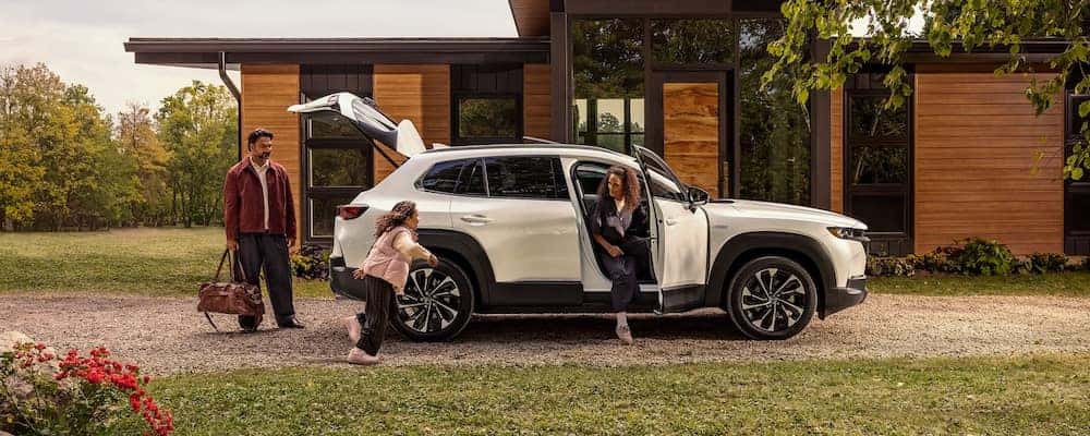 Family getting into their Mazda CX-50 Hybrid SUV