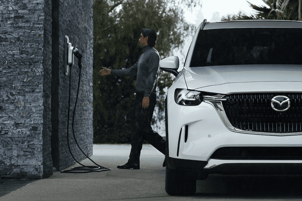 Man charging the Mazda CX-90 PHEV