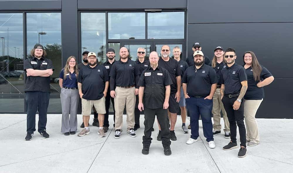 Whitten Brothers Mazda employees standing in front of the Mazda dealership in Richmond, VA