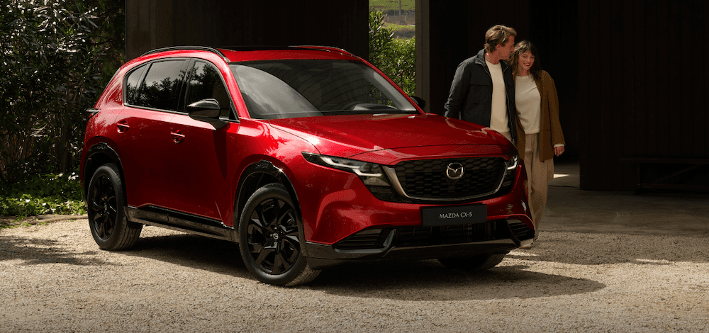 People walking near their red 2026 Mazda CX-5